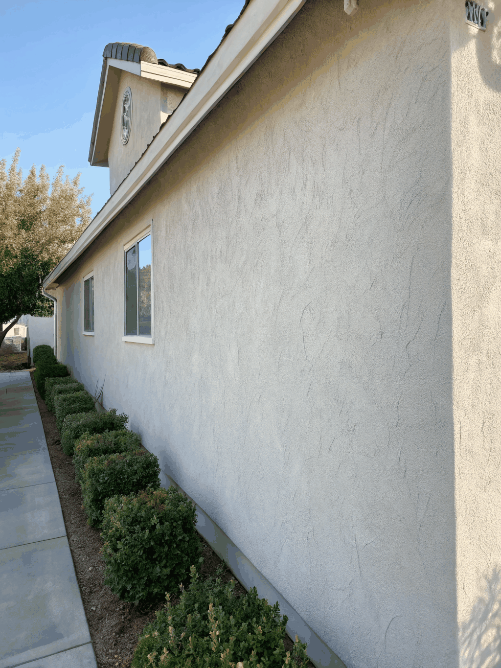 Smooth trowel stucco application on a modern home exterior